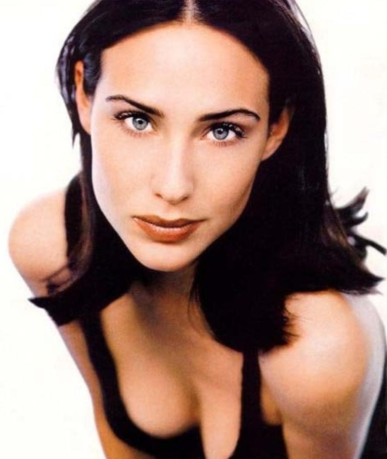 Claire Forlani's free-moving long hair with one side tucked behind