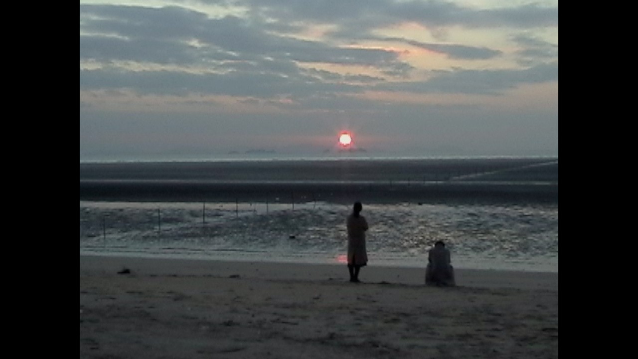 The Waves, the Sand, and Two Lovers in the Middle of...